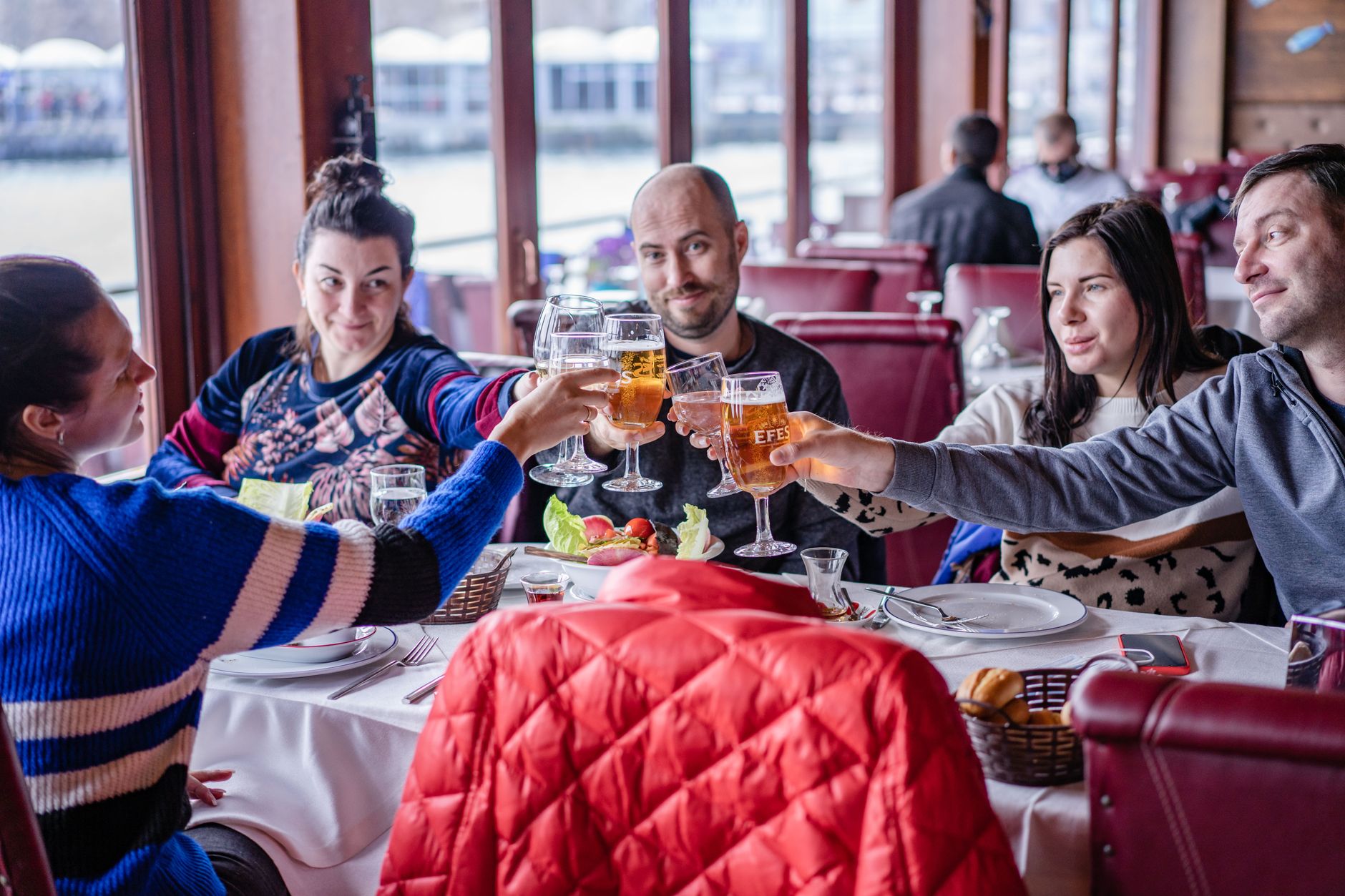 Group of friends raising glasses together in a toast