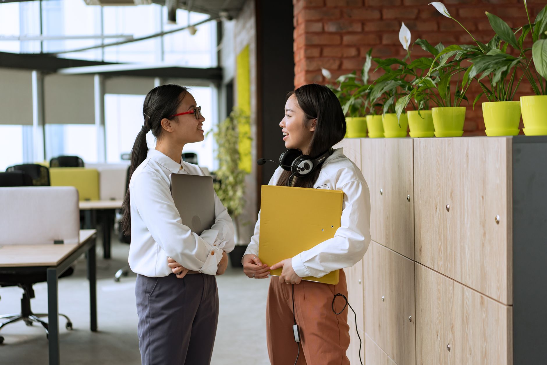 Office colleagues talking and collaborating at work