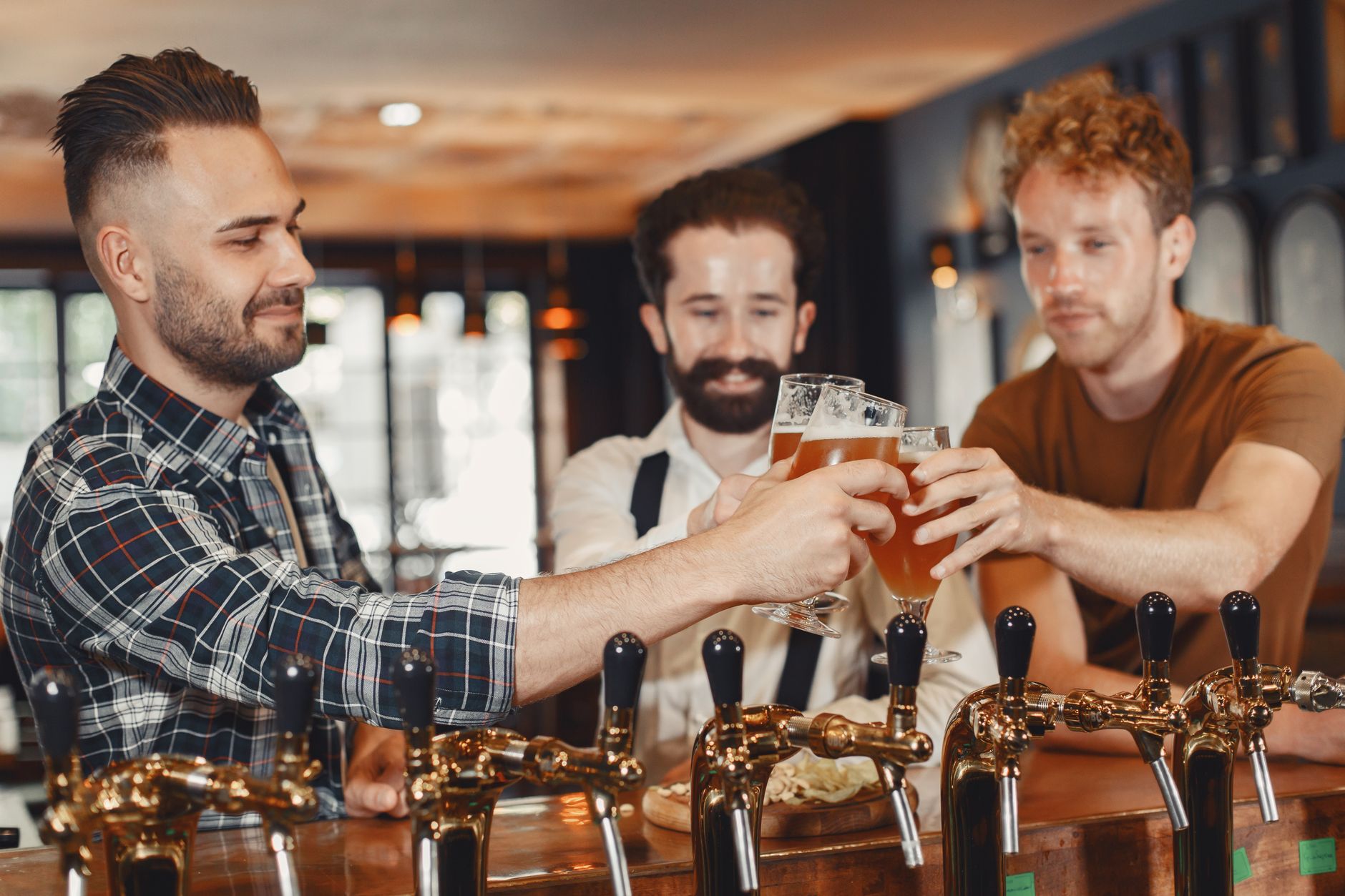 Group of friends toasting drinks at a Korean bar