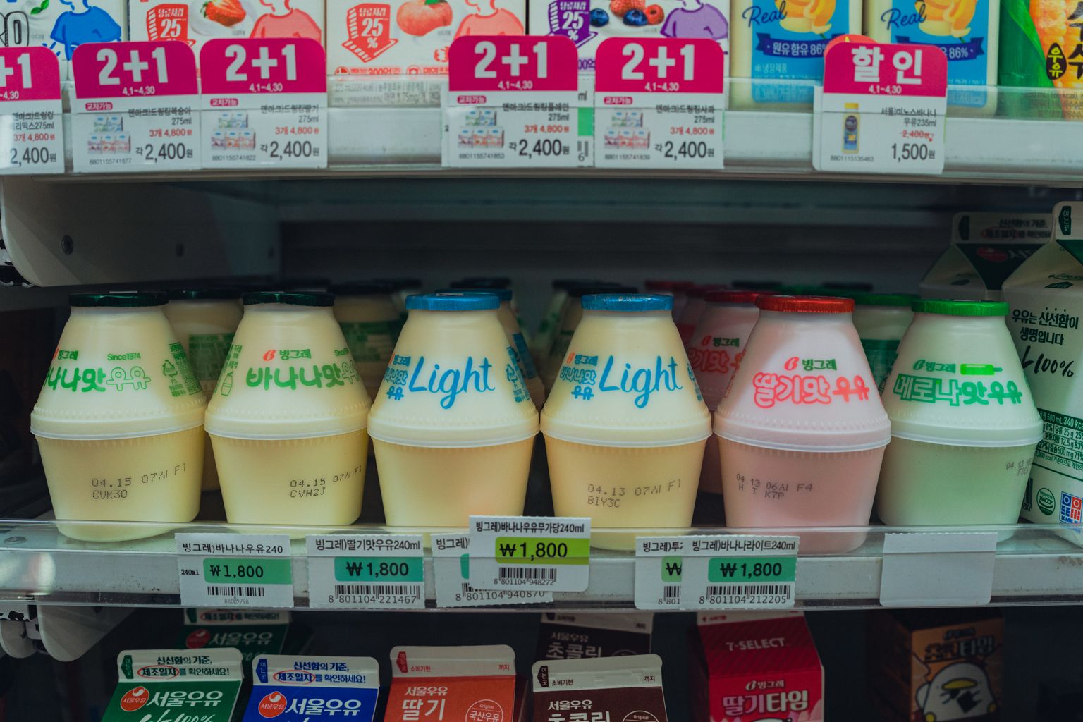 Refrigerated shelves of Korean drinks including banana milk inside a convenience store