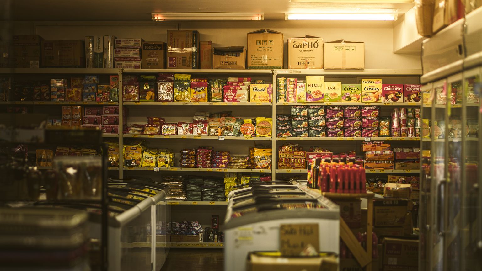 Shelves of packaged Korean snacks and instant noodles inside a convenience store