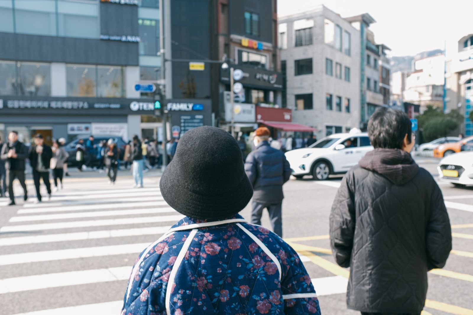 Pedestrians crossing a busy street in Seoul, South Korea