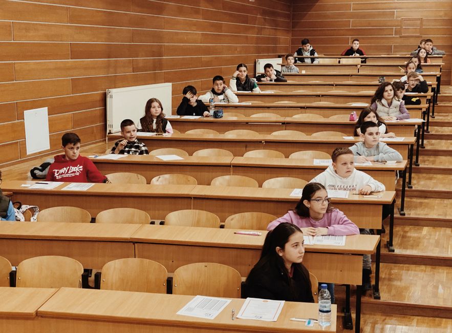 students seated in rows taking an exam