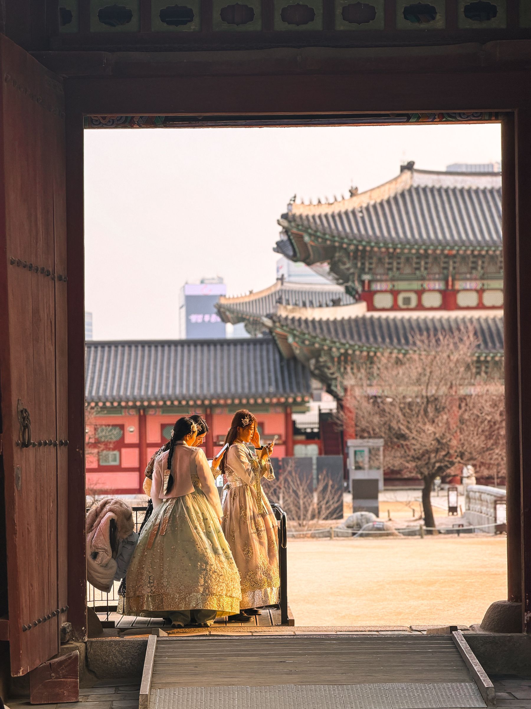Visitors in traditional hanbok exploring Gyeongbokgung Palace in Seoul during a Korean holiday