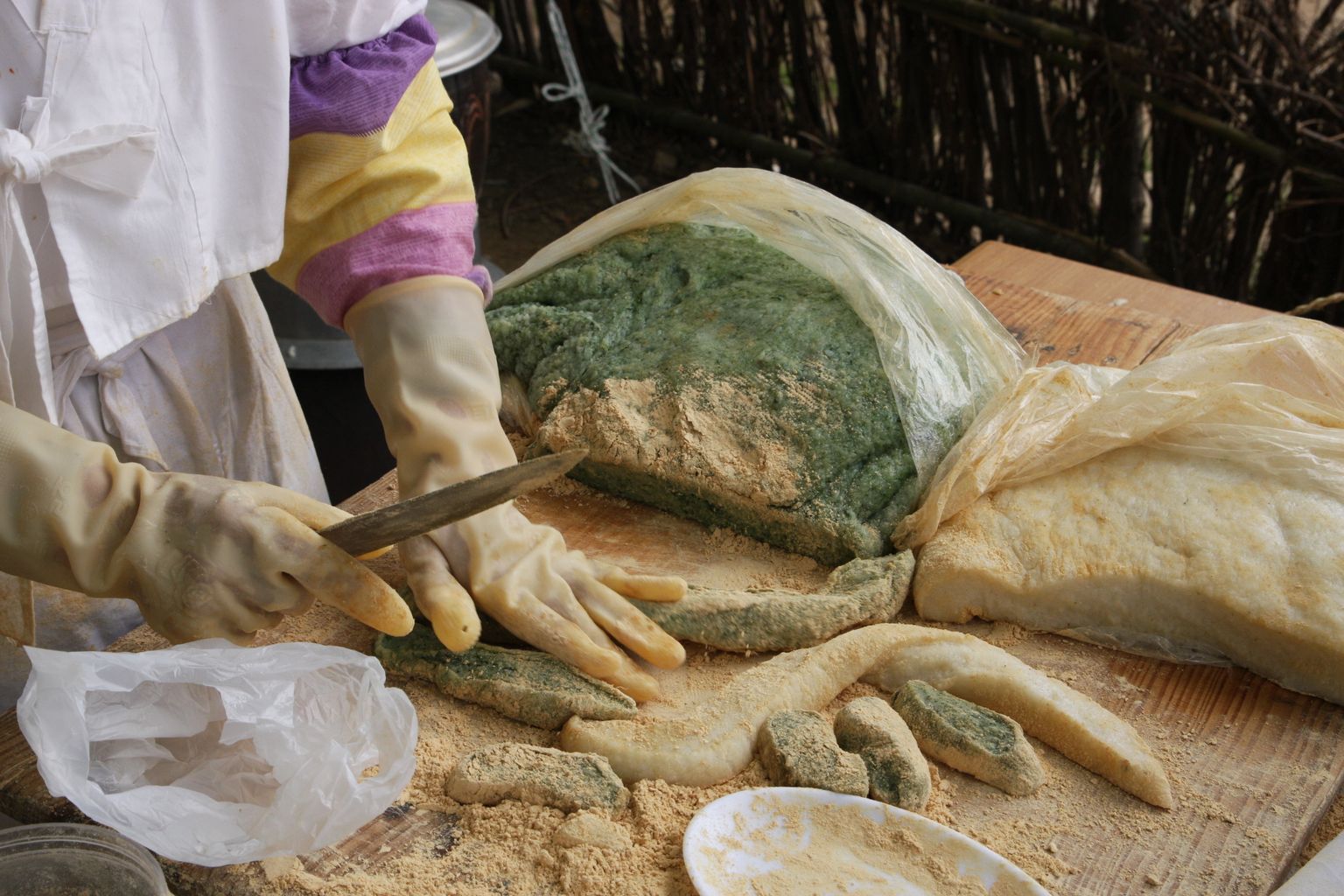 Family preparing traditional Korean rice cakes outdoors ahead of Chuseok