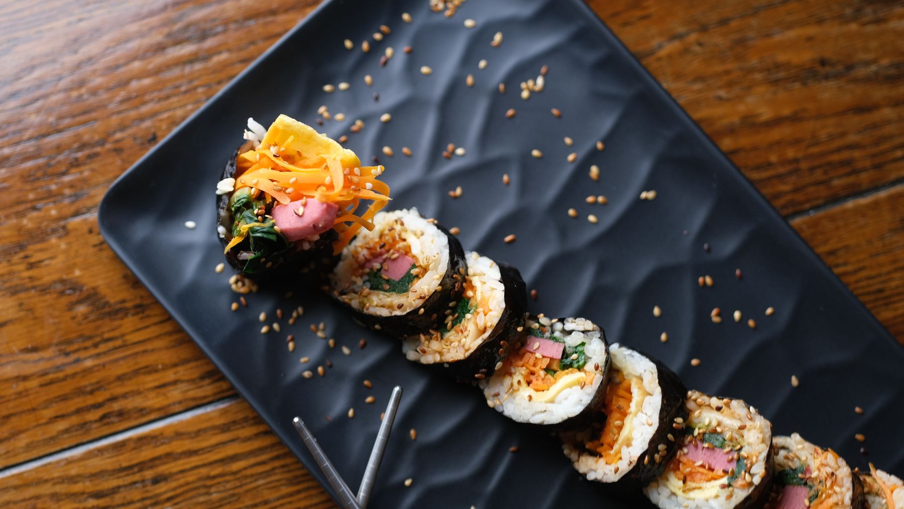 Fresh kimbap rolls sliced and arranged on a tray