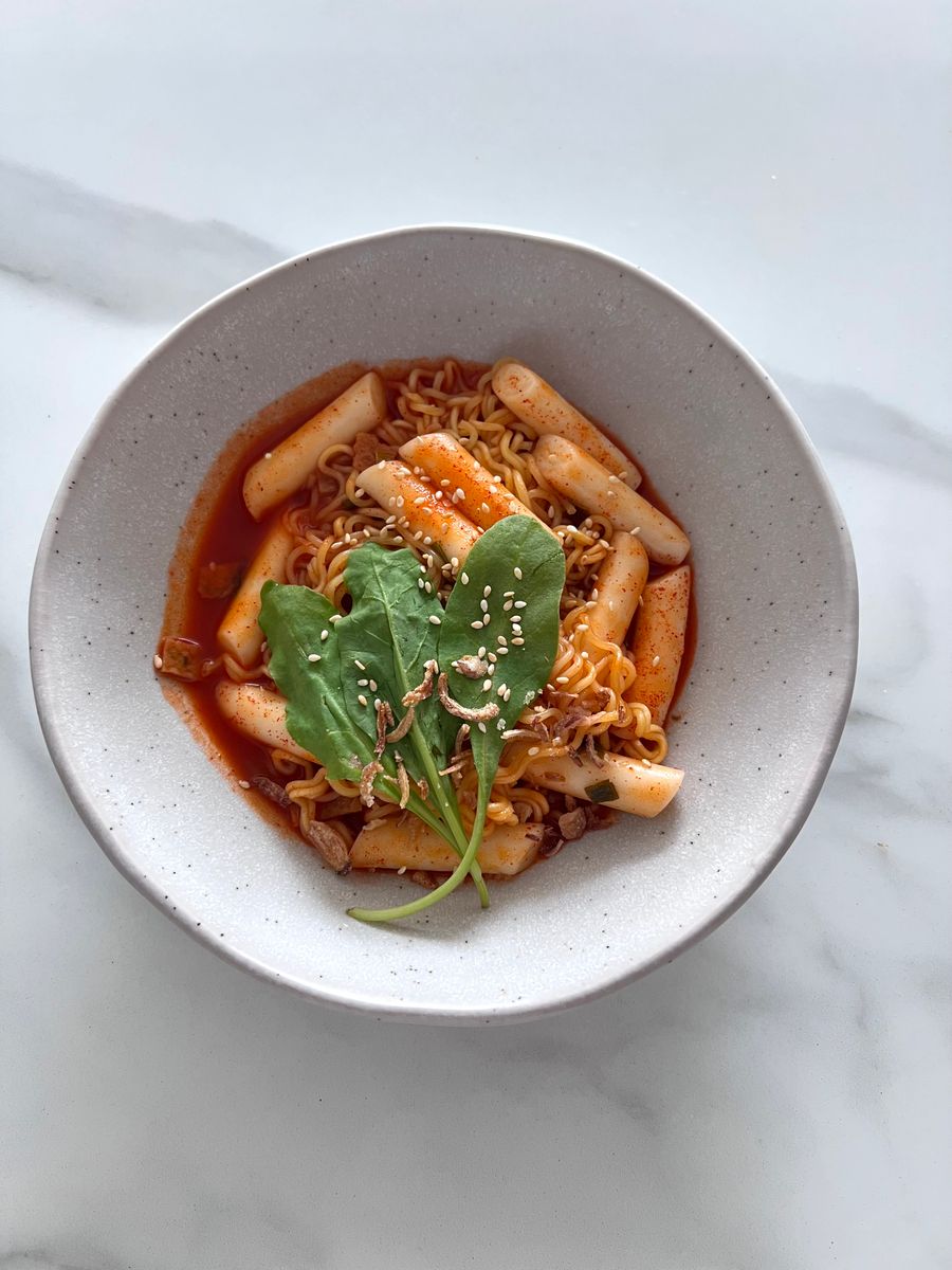 Cheese topped spicy Korean tteokbokki with melted cheese