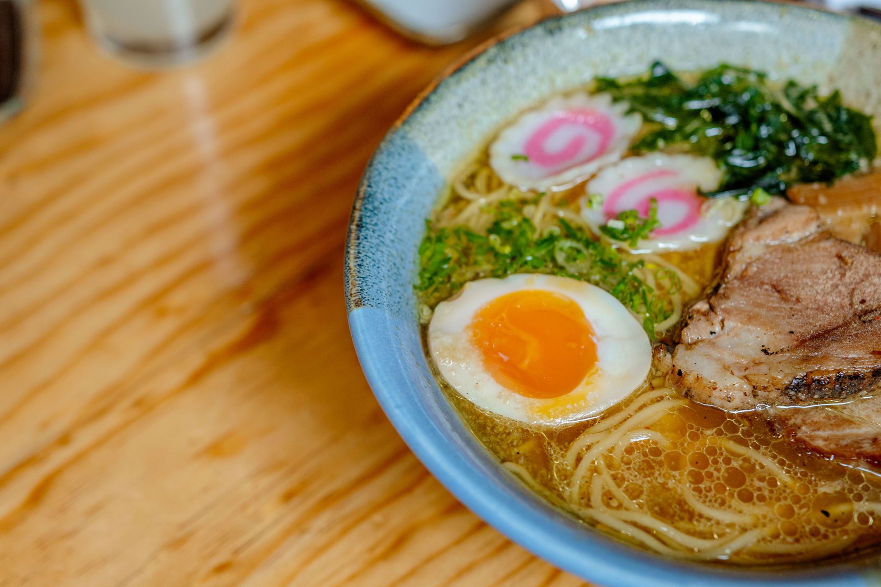 A bowl of ramen noodles with egg and toppings
