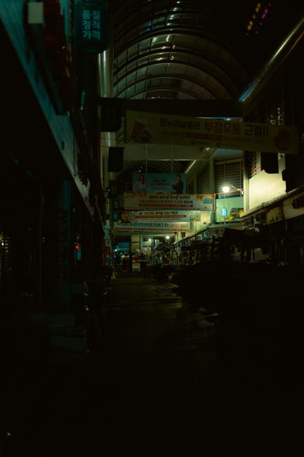 a traditional Korean market street with shop signage