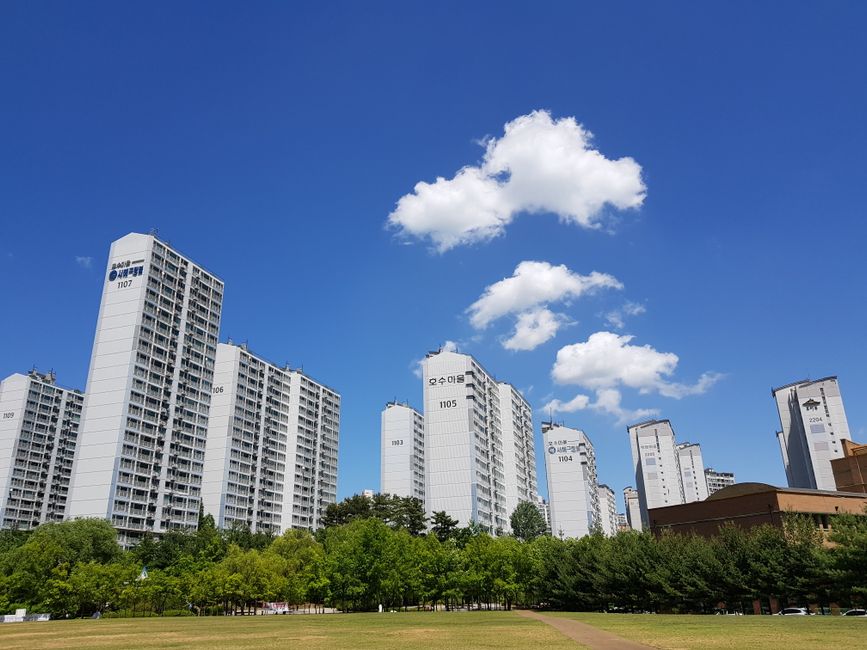 Modern apartment towers in a Korean city under a clear sky