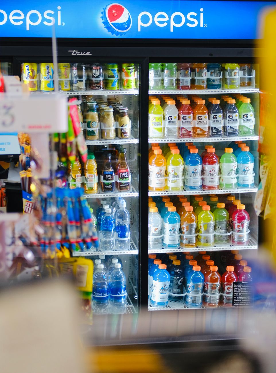 A refrigerated case of drinks and chilled snacks inside a Korean convenience store