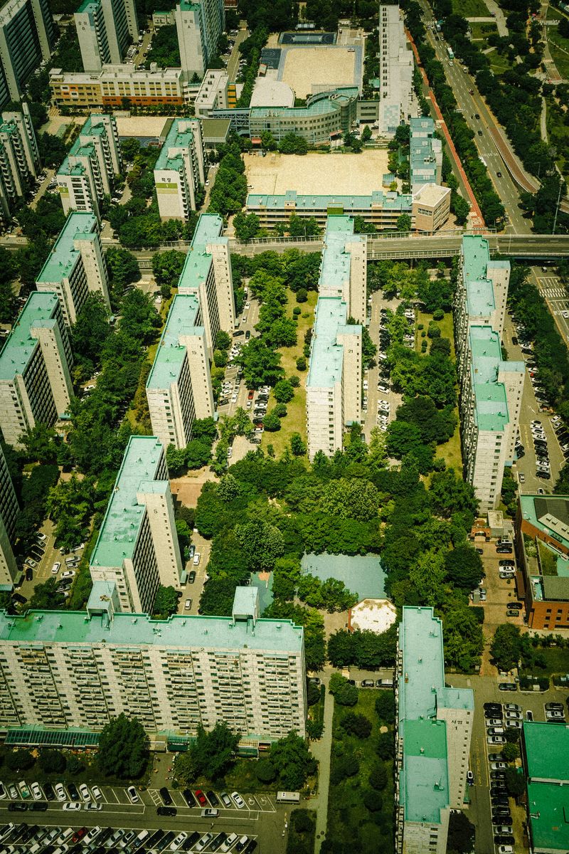 Aerial view of a residential apartment complex surrounded by greenery