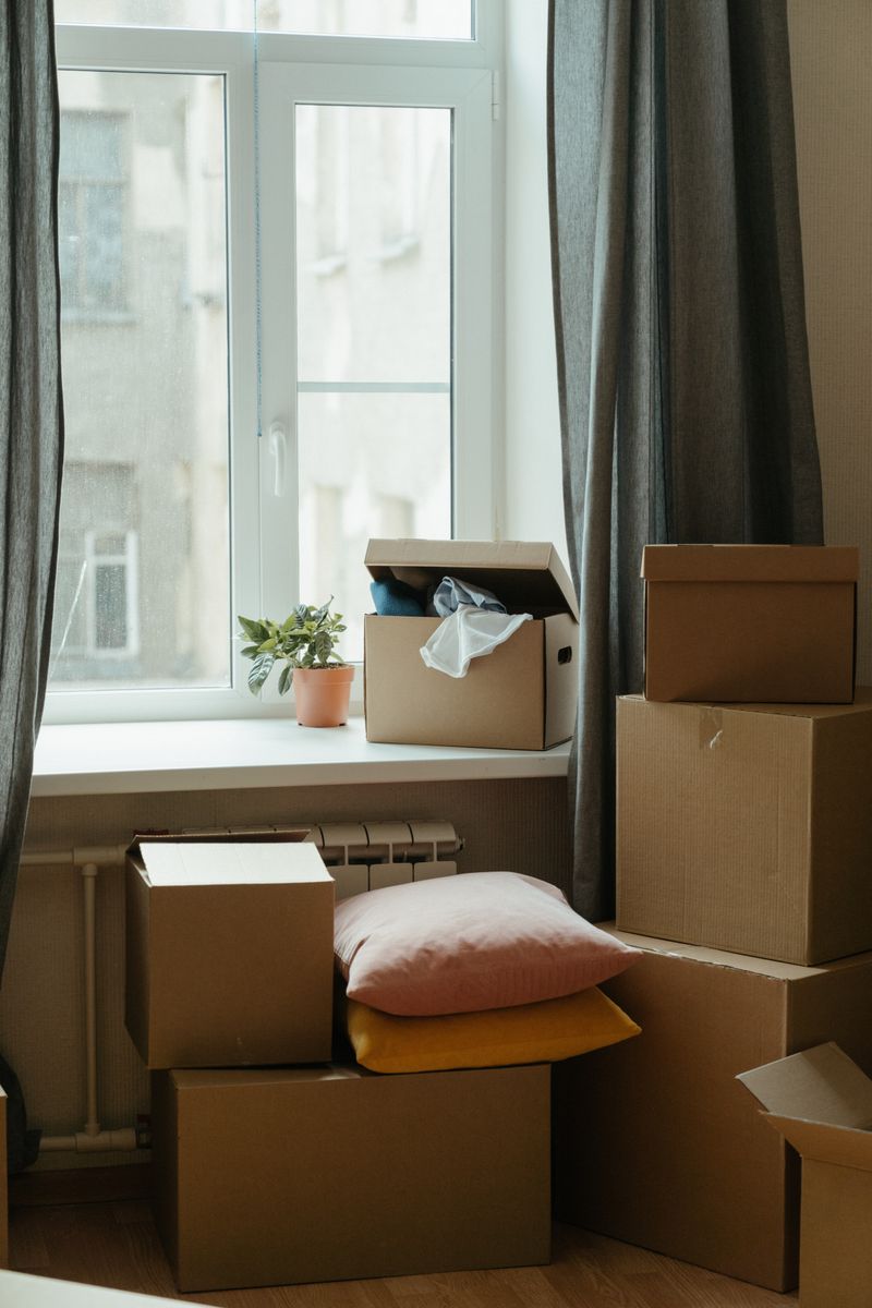 Stack of moving boxes in a sunlit room representing a fresh start