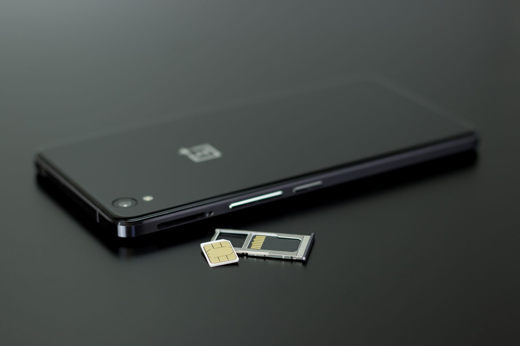 Close-up of a smartphone with a SIM card, representing phone plan setup