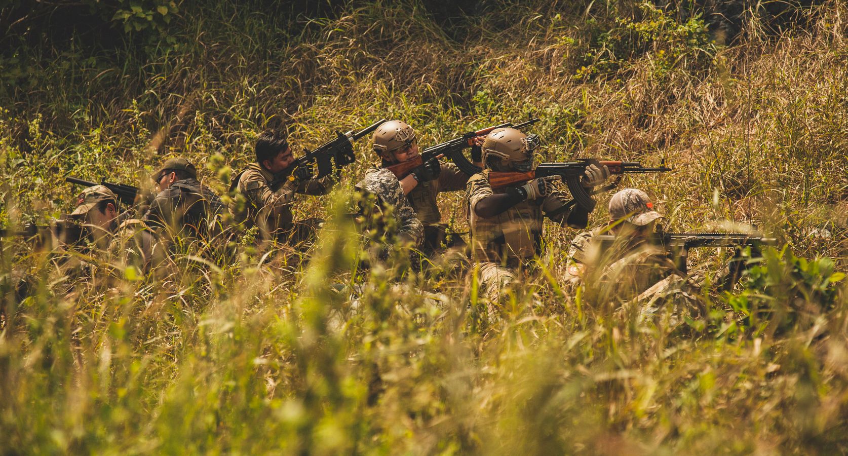 Soldiers in camouflage training outdoors