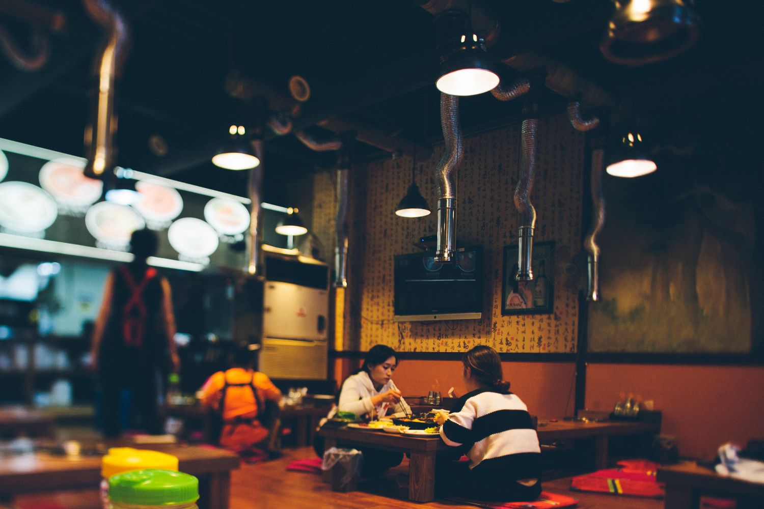 Warmly lit Korean restaurant table set for a group dinner