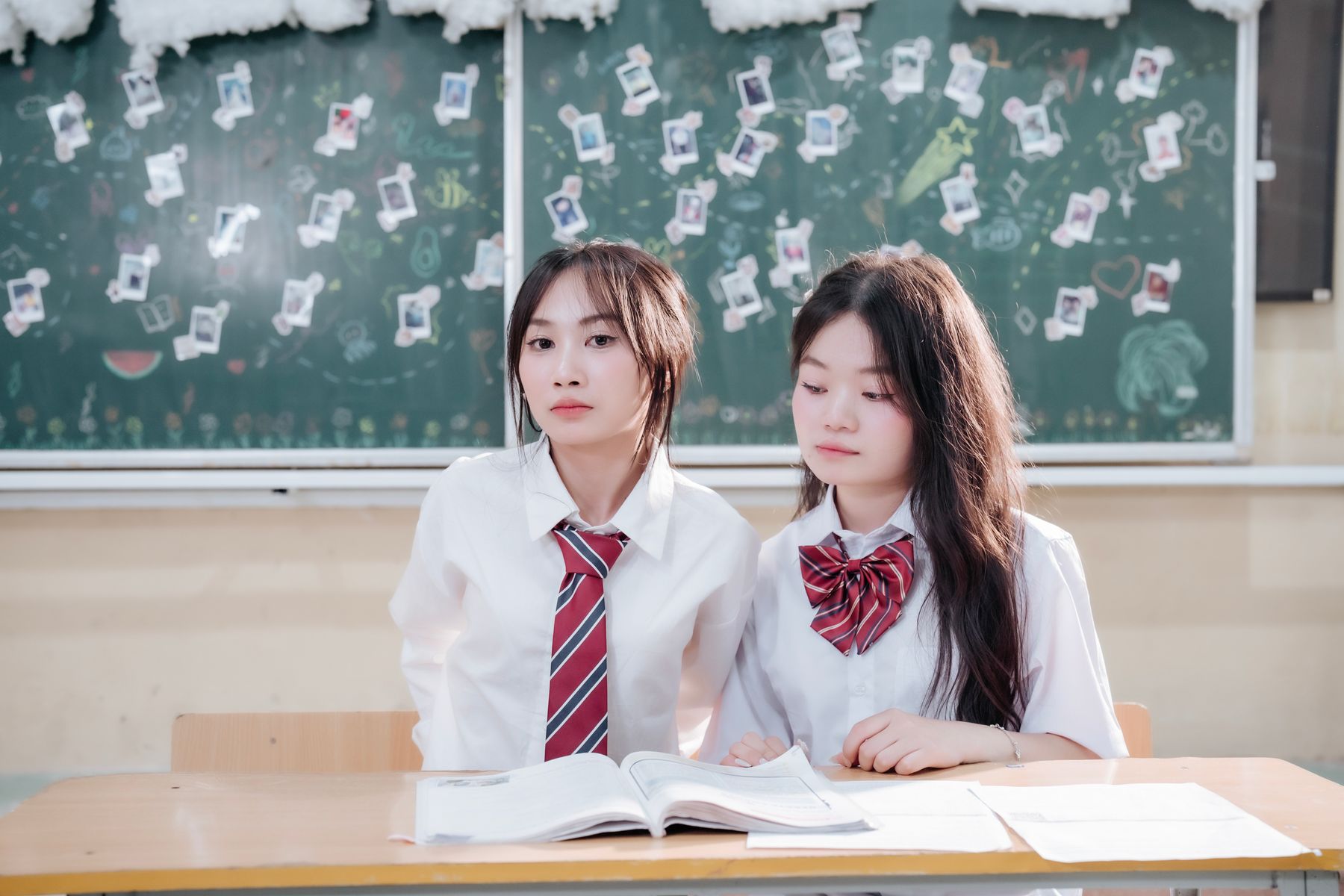 Korean students in uniform studying together in a classroom