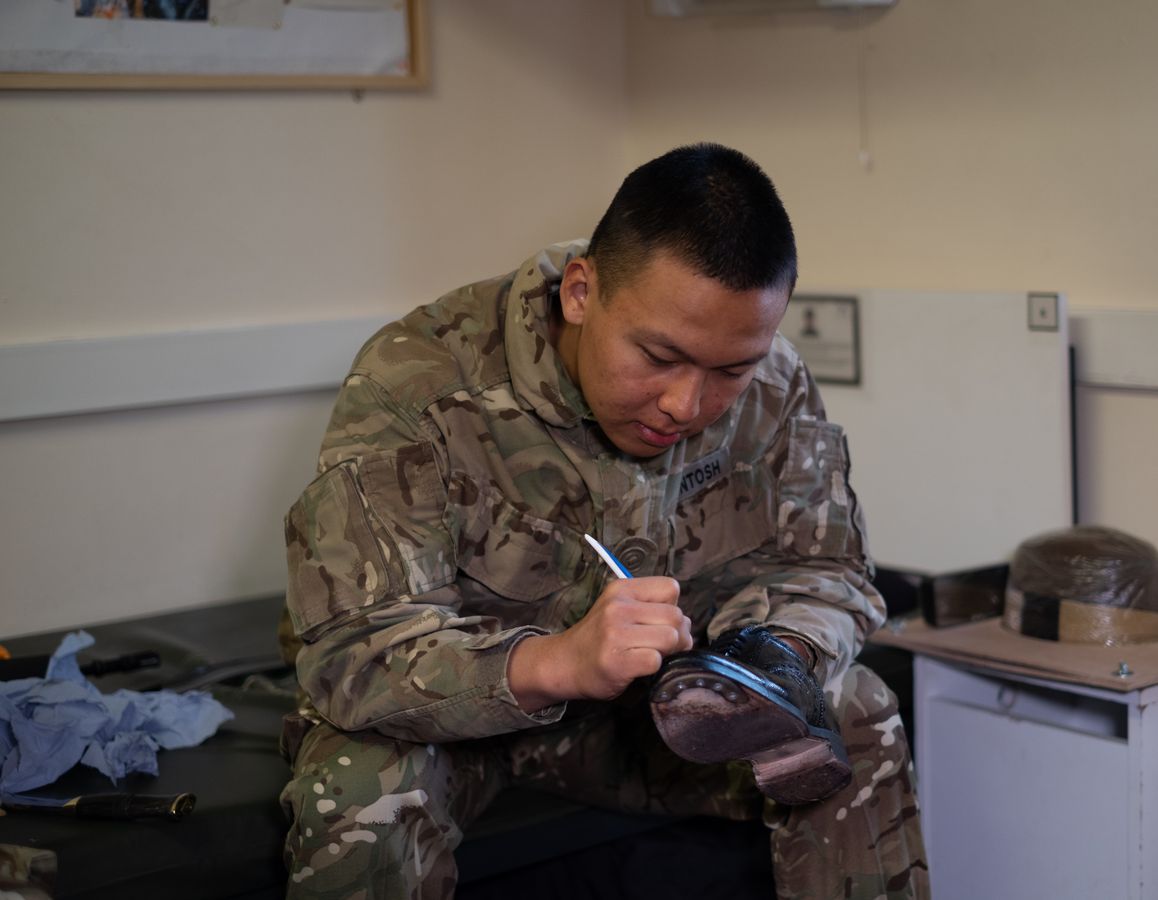 Military boots being polished, symbolizing discipline and routine