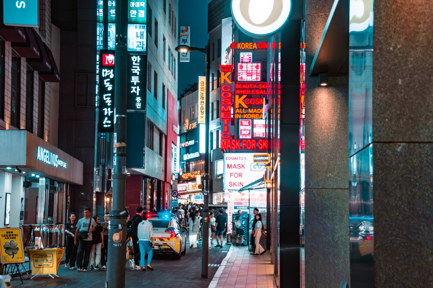 Busy Myeongdong street in Seoul at night with neon signage