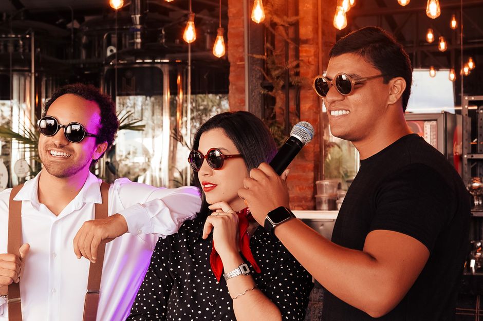 A group of friends enjoying a karaoke session together indoors