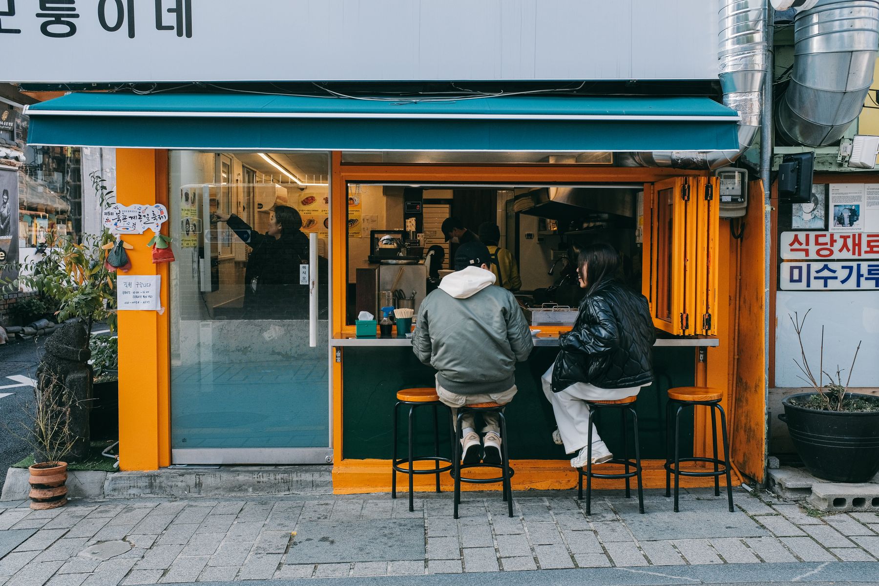 Couple sitting together at a cozy street cafe in Seoul