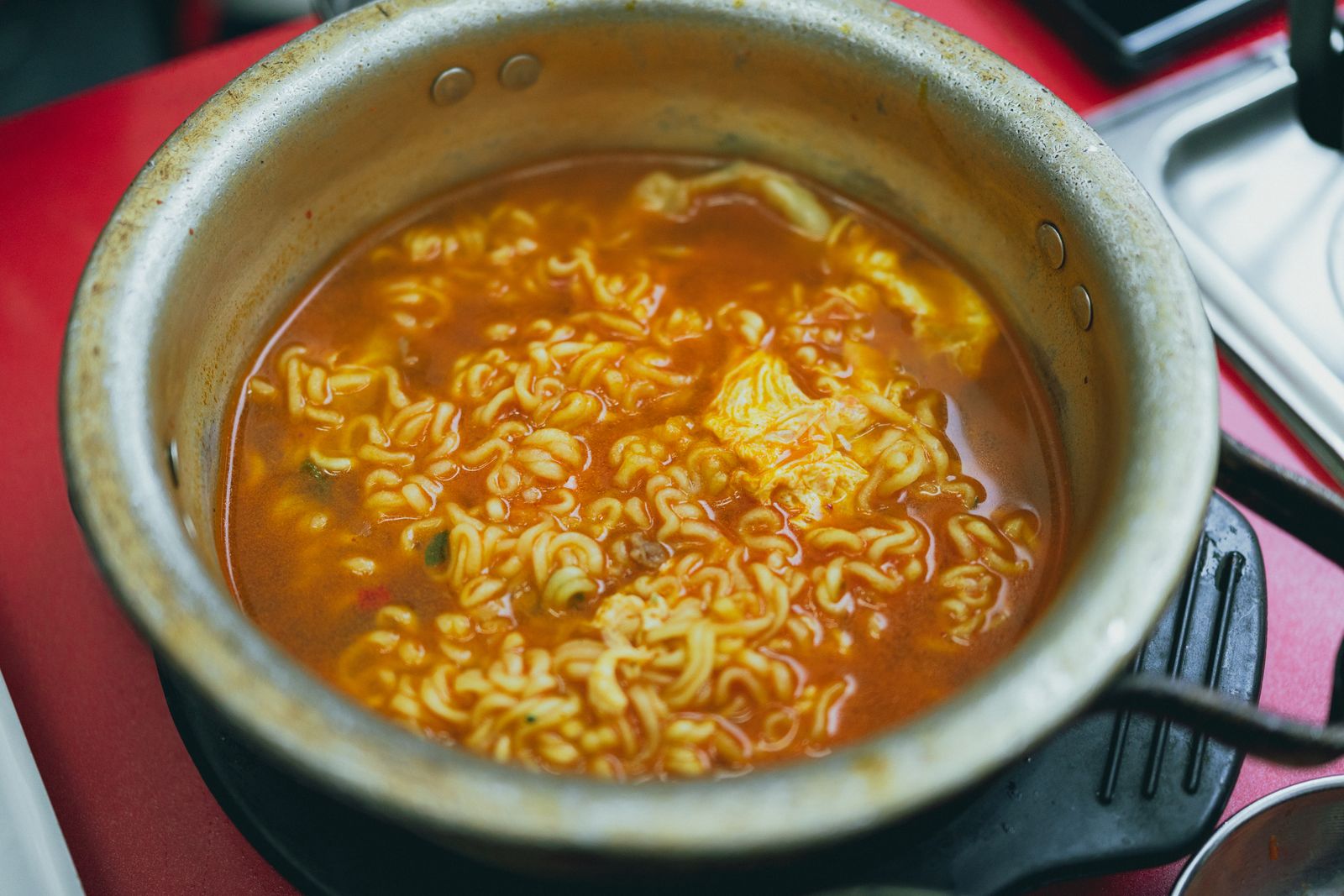 Korean instant ramyeon noodles boiling in a pot