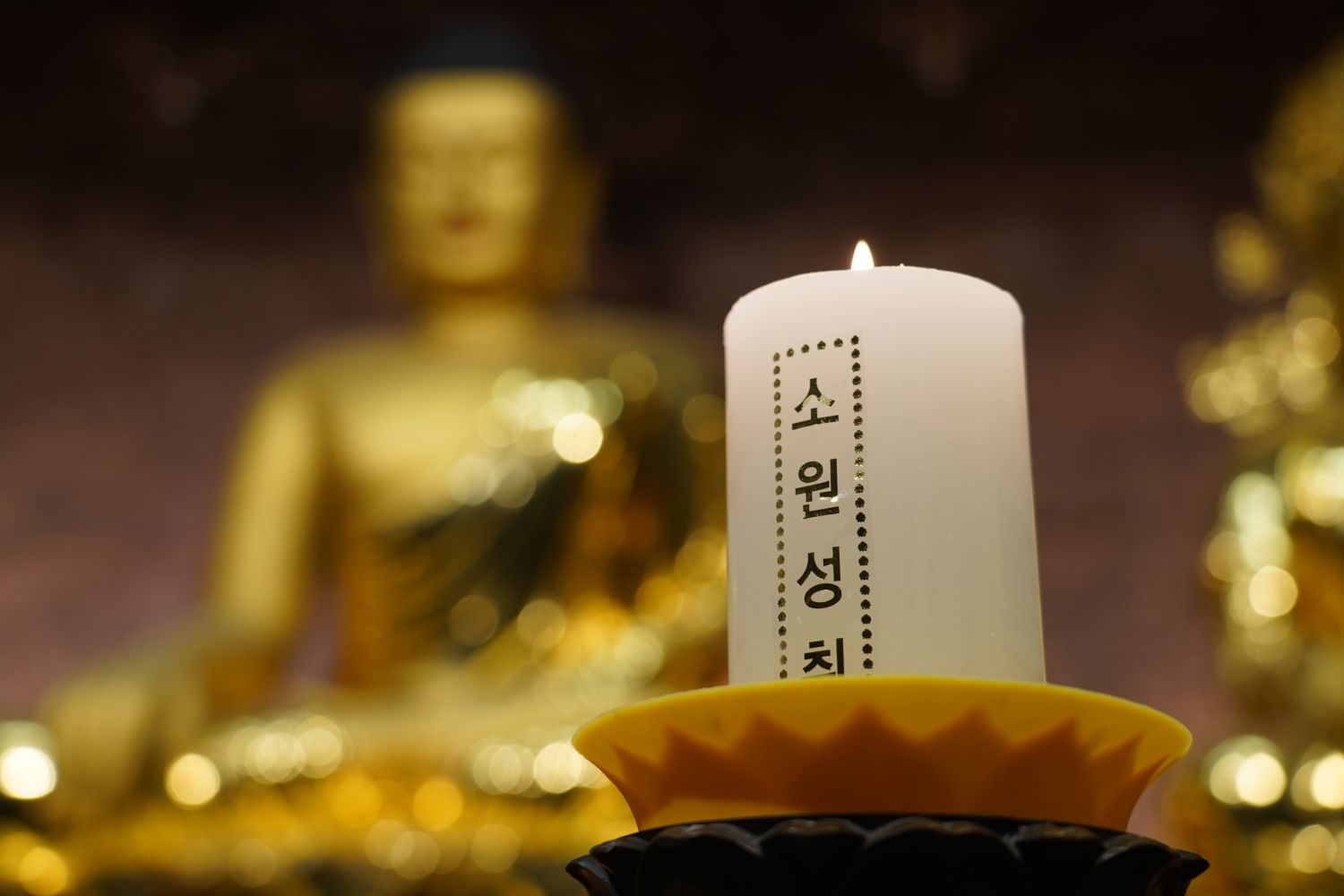 A candle glowing in a Seoul temple, evoking remembrance and ritual