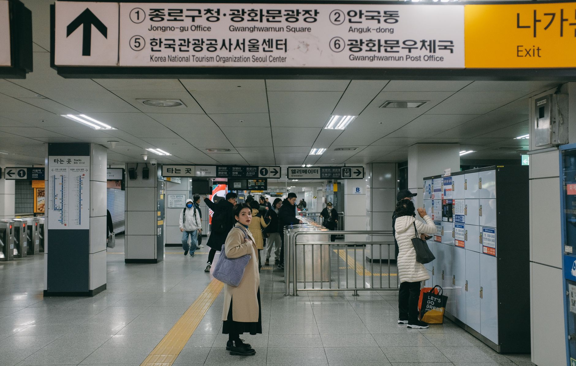 Commuters navigating a busy Seoul subway station