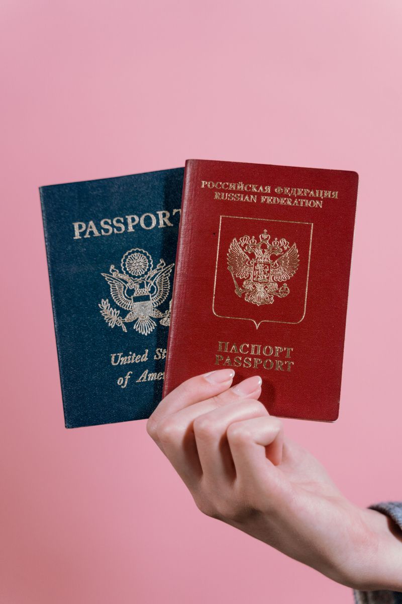 A person holding passports, illustrating how Korean names are rendered differently across official documents