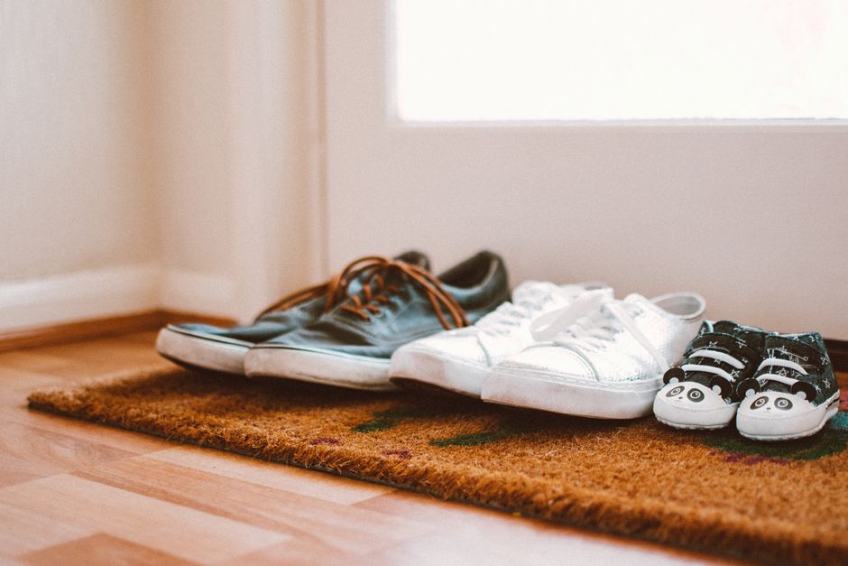Shoes neatly lined up at the entrance of a home